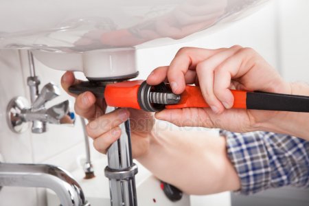 sink depositphotos_29295307-stock-photo-young-plumber-fixing-a-sink